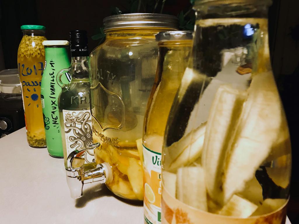 Rum arranged citrus fruits, in aligned bottles